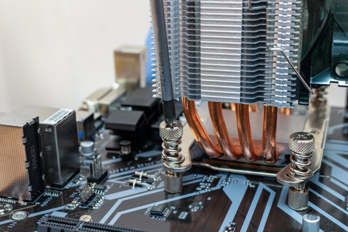 Installing a cooler on a personal computer processor. The process of upgrading computer maintenance in a service.